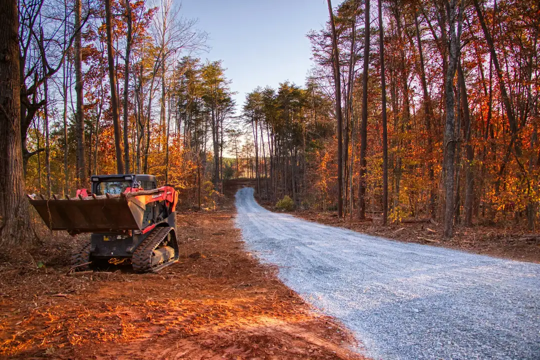 Compact track loader next to a new gravel drive